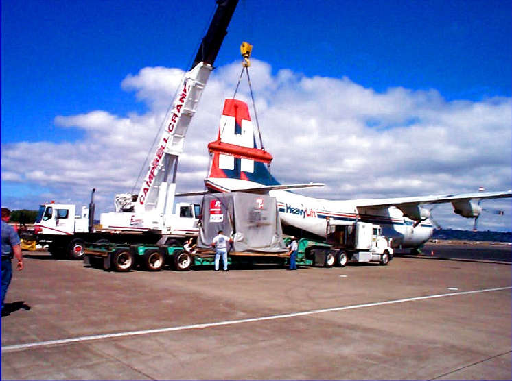 Steamship vessels diesel engine being unloaded in Portland, for delivery to ships side.